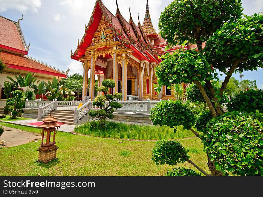 The Ubosot Sanctuary Hall with its steeply pitched, gabled roofs, chofah ornaments, and gilded spire. The Ubosot Sanctuary Hall with its steeply pitched, gabled roofs, chofah ornaments, and gilded spire.