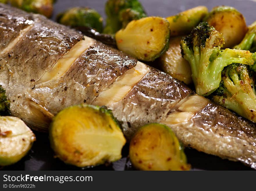 Fried fish with Brussels sprouts, broccoli and lemon