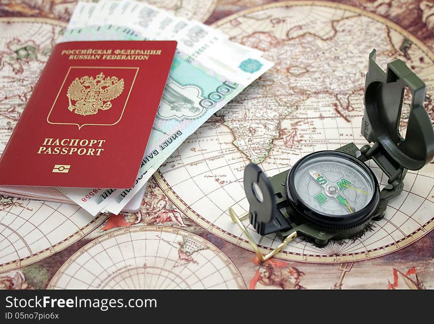 Passport, money and compass. background of the map of the world