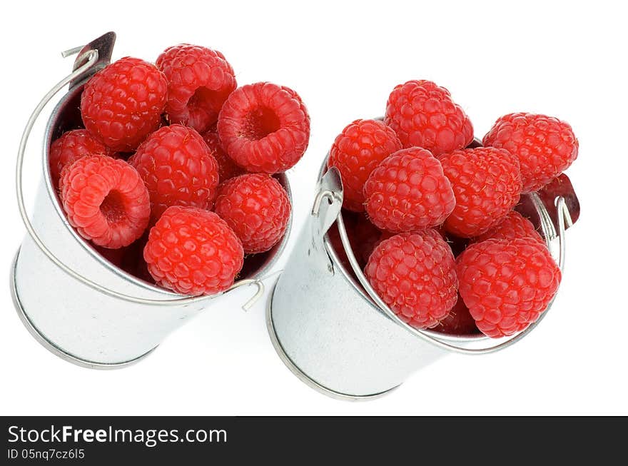 Arrangement of Tin Buckets with Perfect Ripe Raspberries isolated on white background. Arrangement of Tin Buckets with Perfect Ripe Raspberries isolated on white background