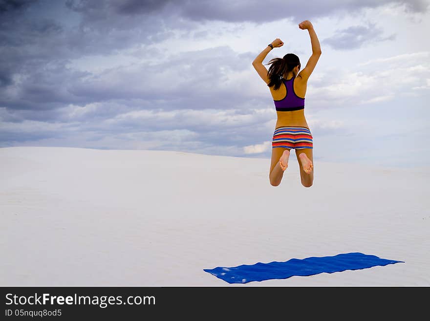 Athletic woman enjoying yoga in secluded desert oasis.