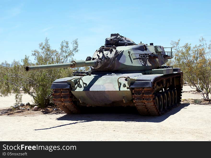 Old tank in a desert junkyard with blue sky. Old tank in a desert junkyard with blue sky