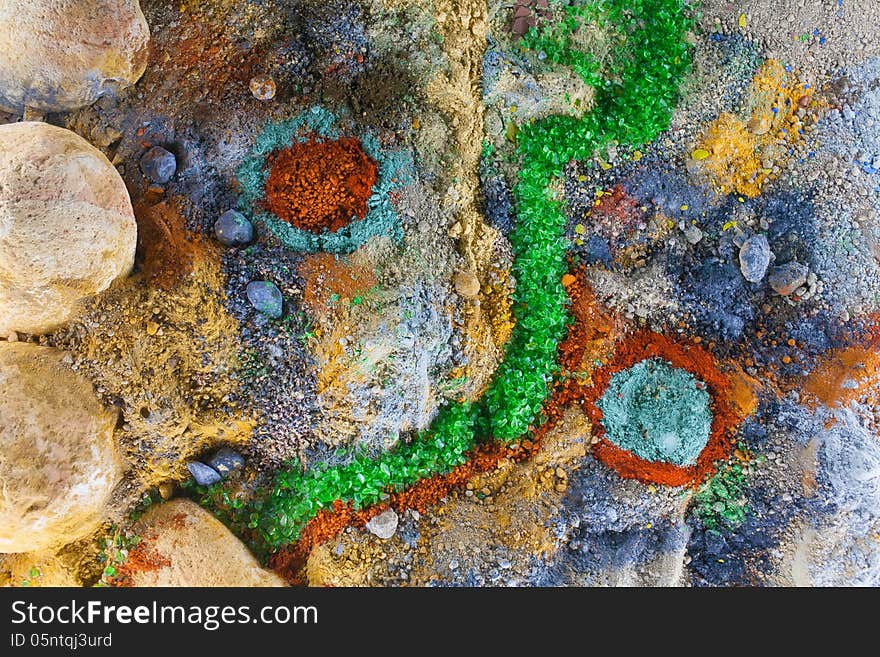 Close up on an abstract composition made by multicolored sand and pebbles. Close up on an abstract composition made by multicolored sand and pebbles