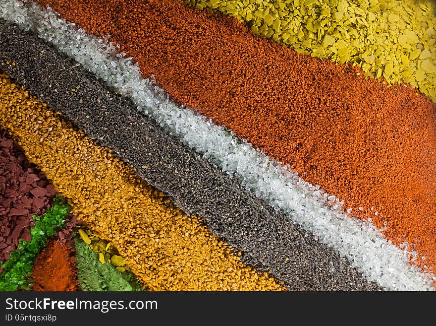 Close up on an abstract composition made by multicolored sand and pebbles. Close up on an abstract composition made by multicolored sand and pebbles