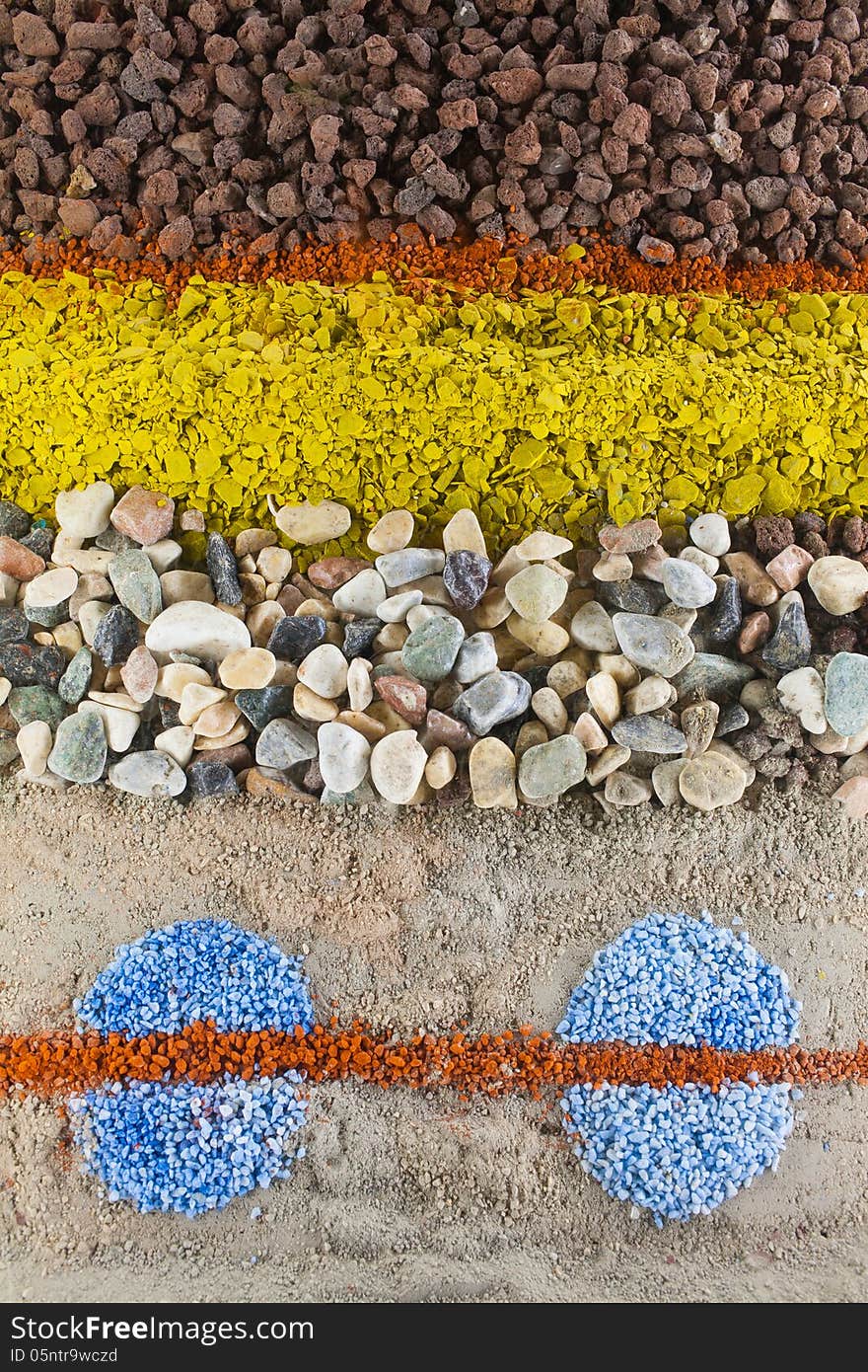 Close up on an abstract composition made by multicolored sand and stones. Close up on an abstract composition made by multicolored sand and stones