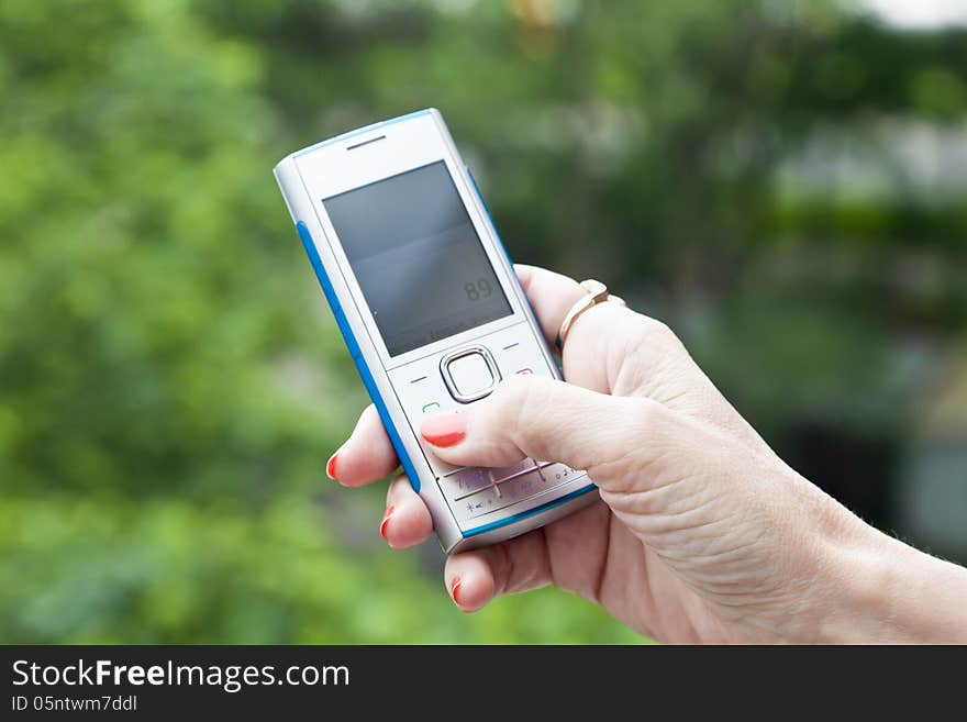 Mobile phones separately and together, sometimes with a hand of the woman