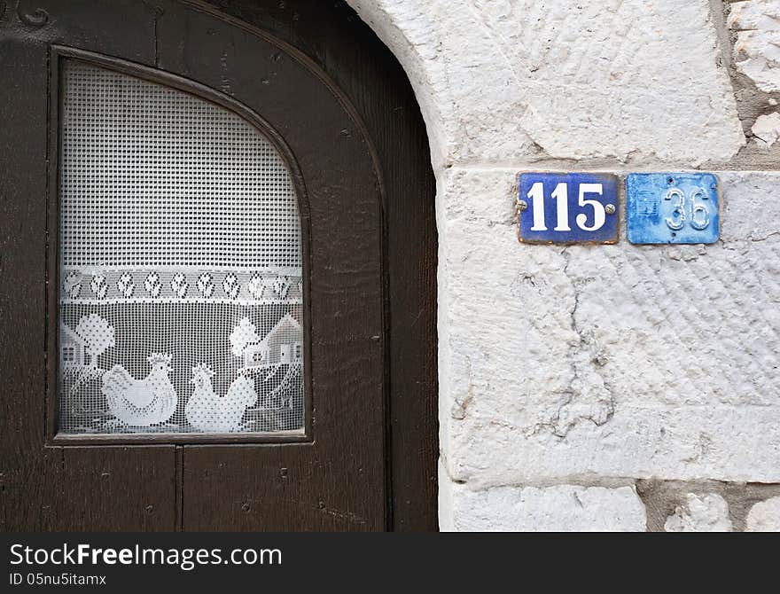 Vintage window with curtains on white brick wall. Belgium