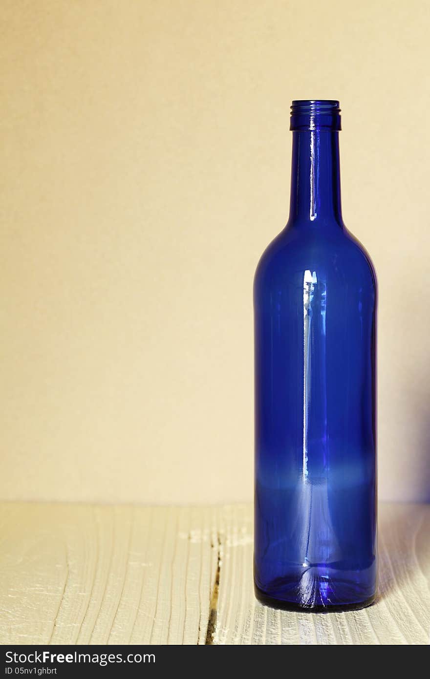 Wine bottle on wood table with wall background