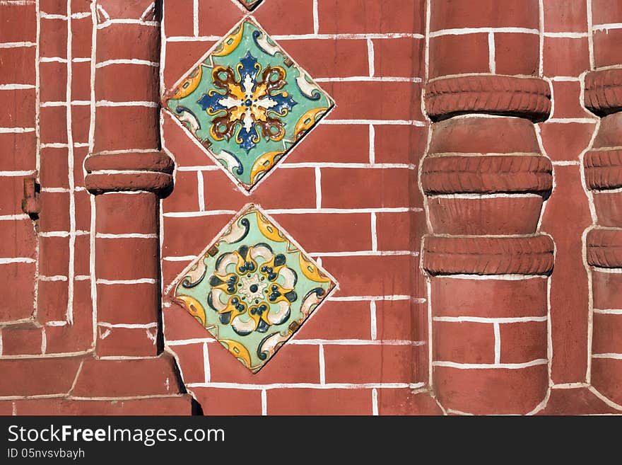 Detailed red brick wall fragment of ancient Russian Orthodox Church in Yaroslavl city with traditional ceramic tile decoration. Detailed red brick wall fragment of ancient Russian Orthodox Church in Yaroslavl city with traditional ceramic tile decoration