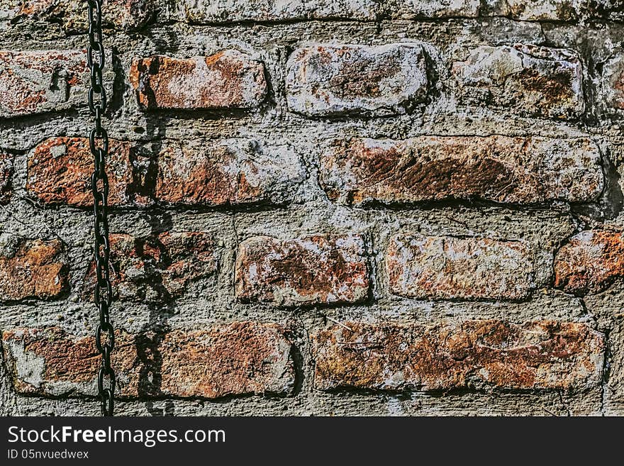 Medieval fortress antique brick rampart with chain, detail. Medieval fortress antique brick rampart with chain, detail.