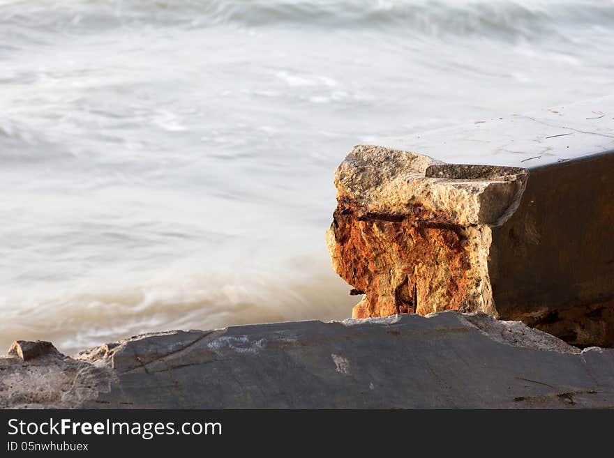 Broken Cement wall sea wave iron Rust