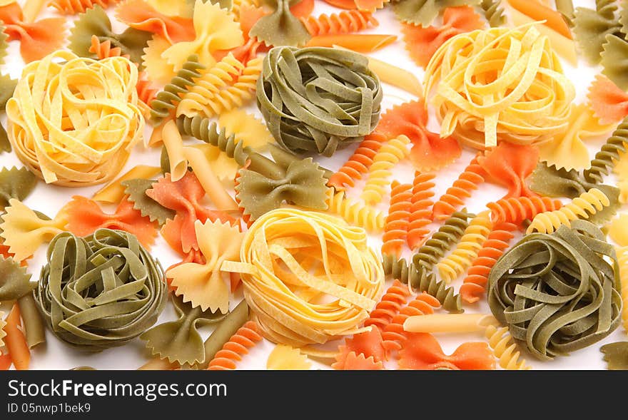 A different pasta in three colors on the white background.