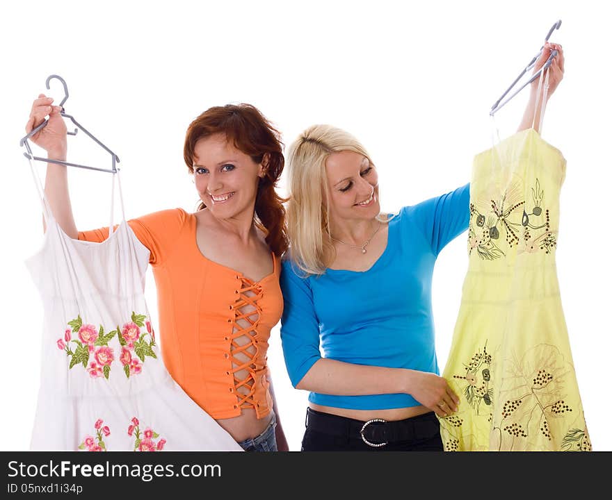 Two women shopping for new clothes, isolated on a white background. Two women shopping for new clothes, isolated on a white background.