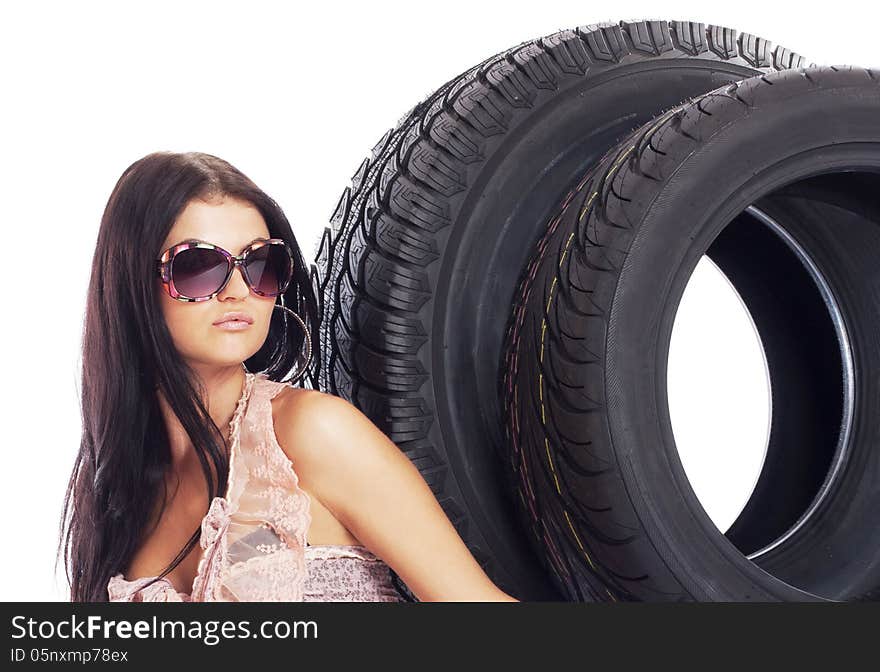 Young girl holding a car wheel, isolated on white. Young girl holding a car wheel, isolated on white.