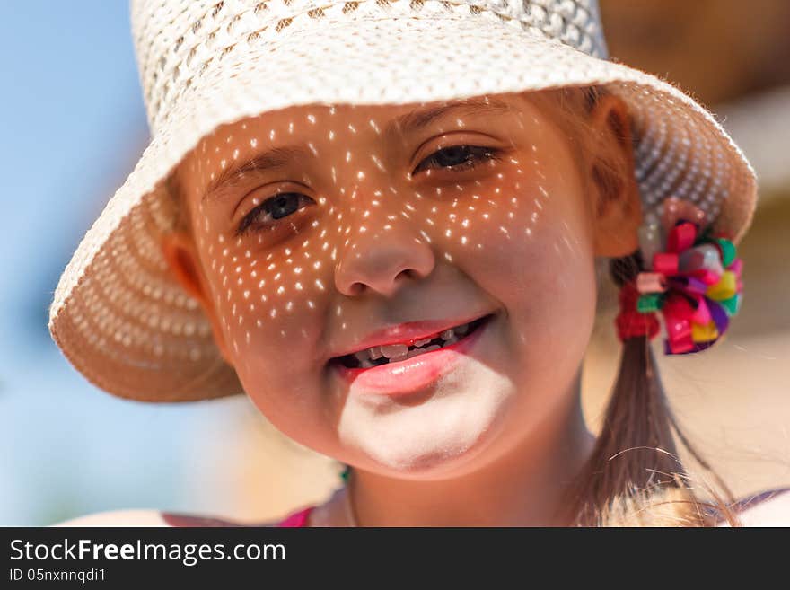 Girl in a white hat smiling