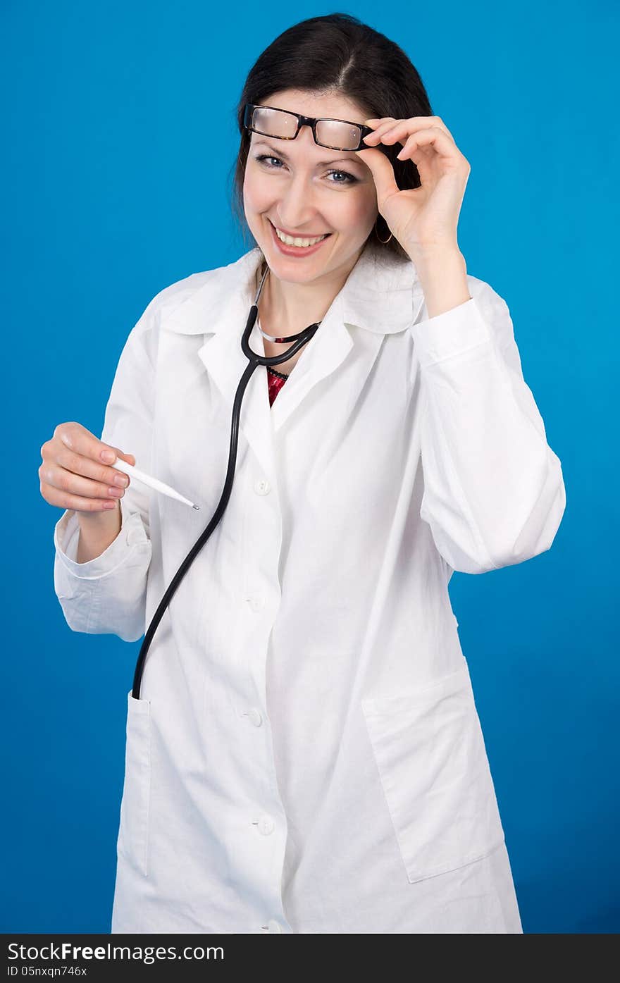 Happy doctor with a thermometer on a blue background. Happy doctor with a thermometer on a blue background