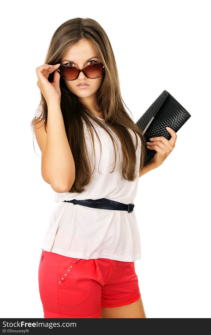 Glamor beautiful girl in sunglasses and clutches