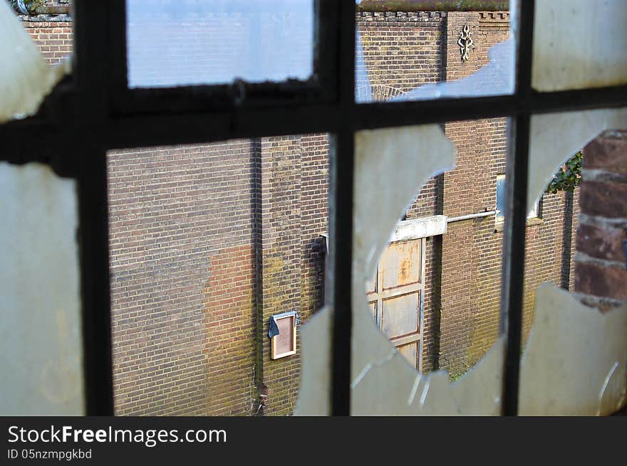 Broken window of an abandoned factory. Broken window of an abandoned factory