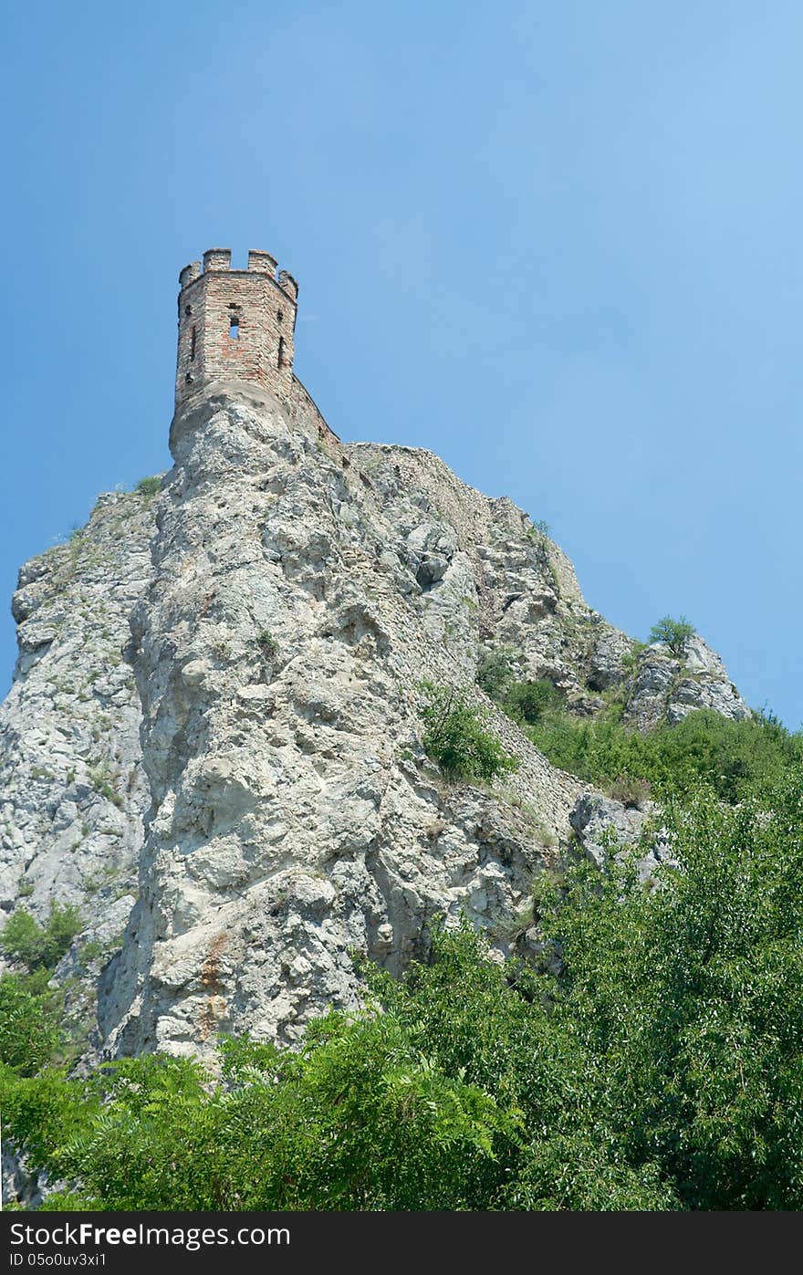 Maiden tower on sky background. Devin castle (864 - 15th century). Bratislava, Slovakia. Last fortifications built in the 17th century. Separated from the main castle, Maiden Tower balances perilously on a lone rock and has spawned countless legends concerning imprisoned lovelorn daughters leaping to their deaths. Maiden tower on sky background. Devin castle (864 - 15th century). Bratislava, Slovakia. Last fortifications built in the 17th century. Separated from the main castle, Maiden Tower balances perilously on a lone rock and has spawned countless legends concerning imprisoned lovelorn daughters leaping to their deaths