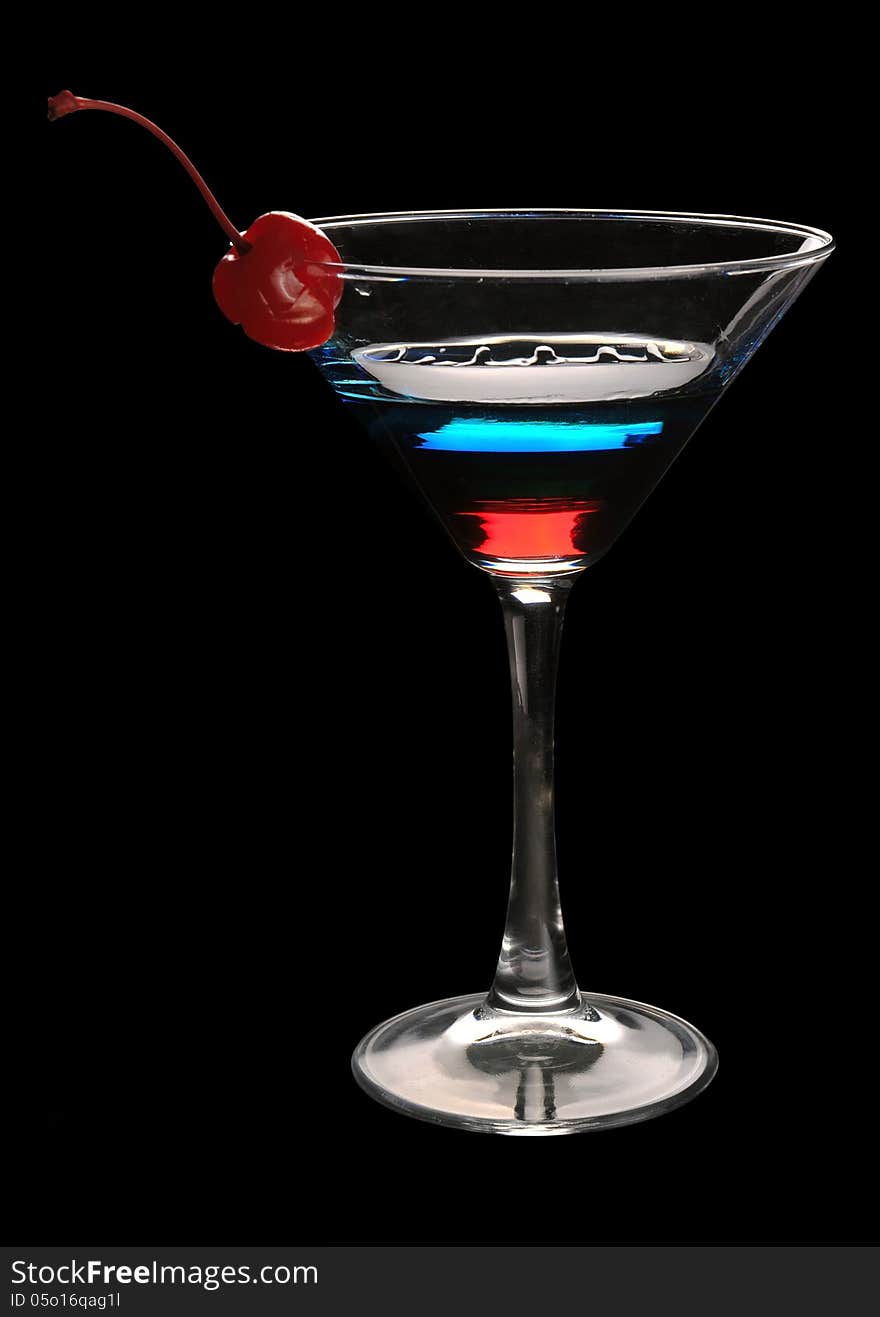 Tri-color cocktail martini with a cherry