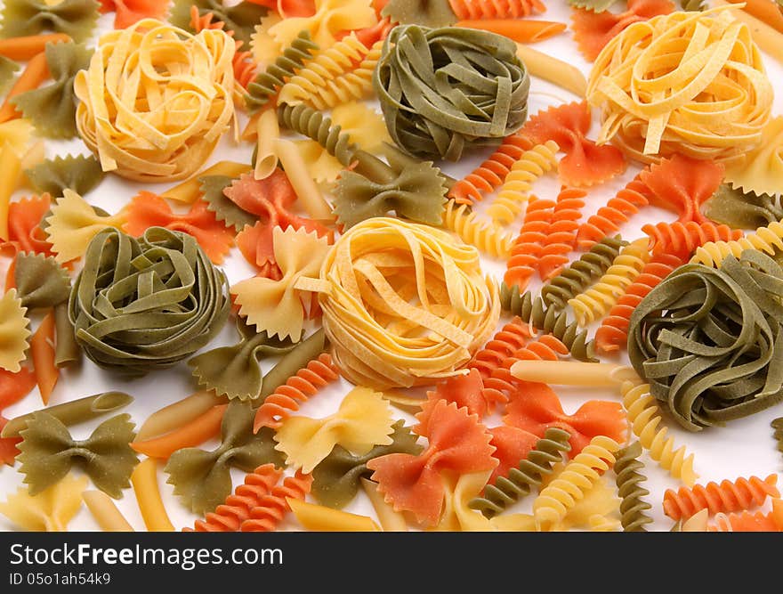 A different pasta in three colors on the white background. A different pasta in three colors on the white background.