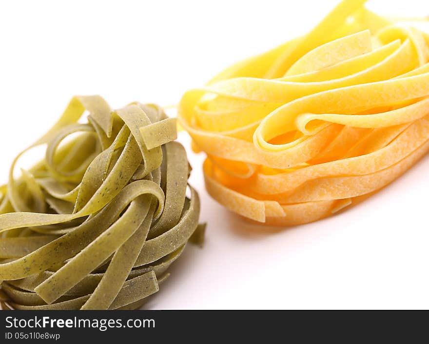 Tagliatelle paglia e fieno tipycal italian pasta close-up on the white background