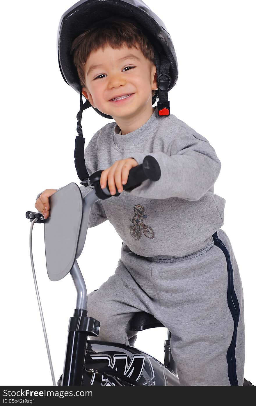 Smiley boy with helmet demonstrate riding a bicycle. He wears grey sport clothes. Smiley boy with helmet demonstrate riding a bicycle. He wears grey sport clothes.