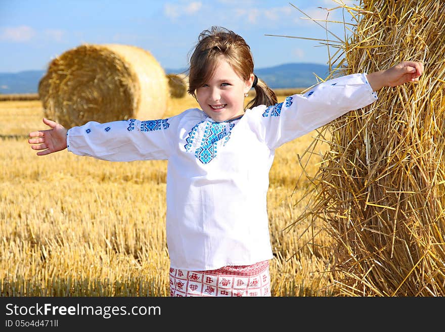 Small rural girl on harvest field