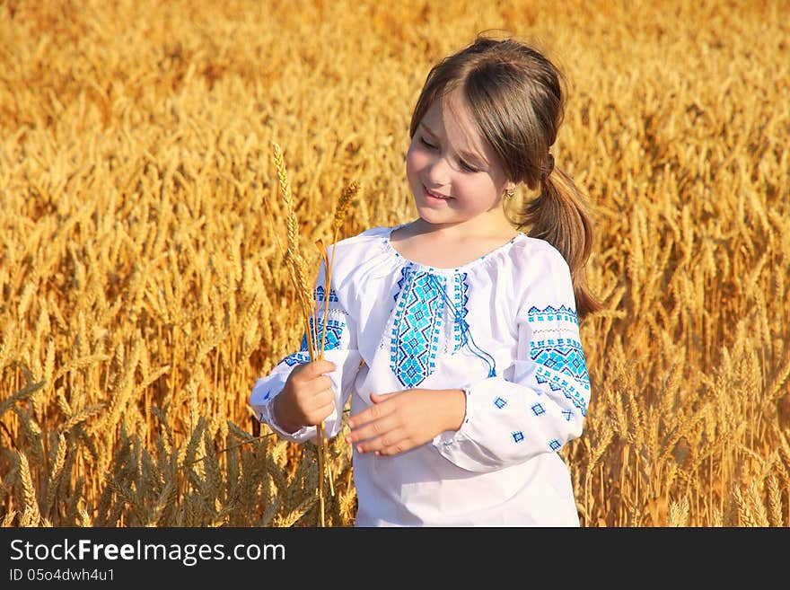 Small rural girl on wheat field