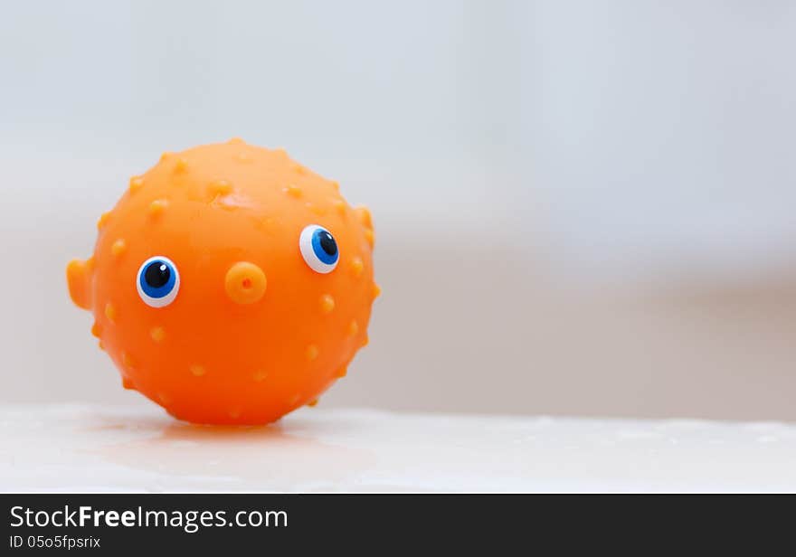 Small orange puffer fish children's water toy. Small orange puffer fish children's water toy.