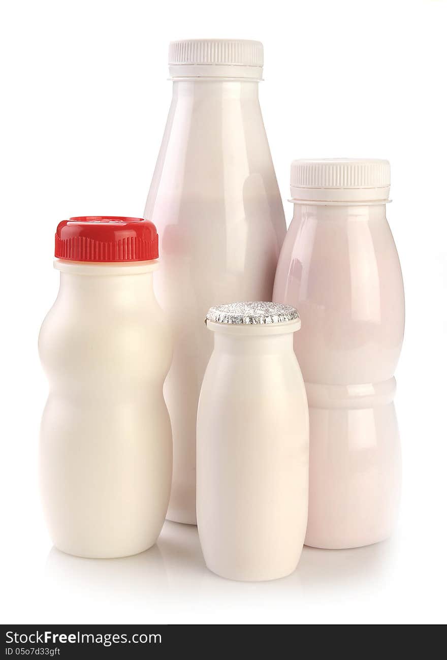 Various bottles of yogurt on a white background