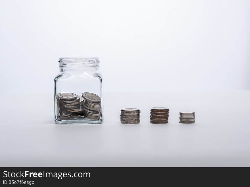 Coin stacks and glass bottle. Coin stacks and glass bottle