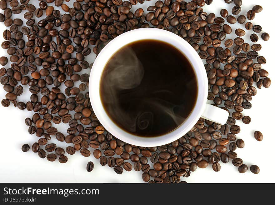 Coffee cup and coffee beans on white background