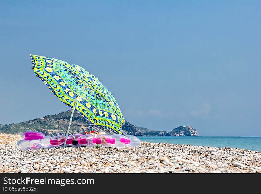 Sunshade and air bed on the beach. Sunshade and air bed on the beach