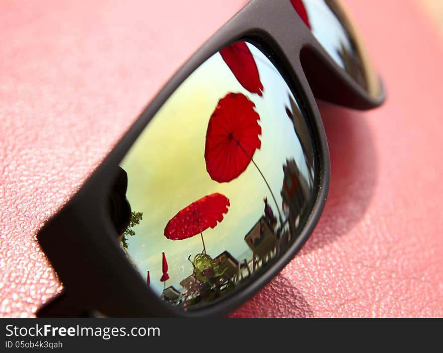 Rainbow sun glasses on a red background