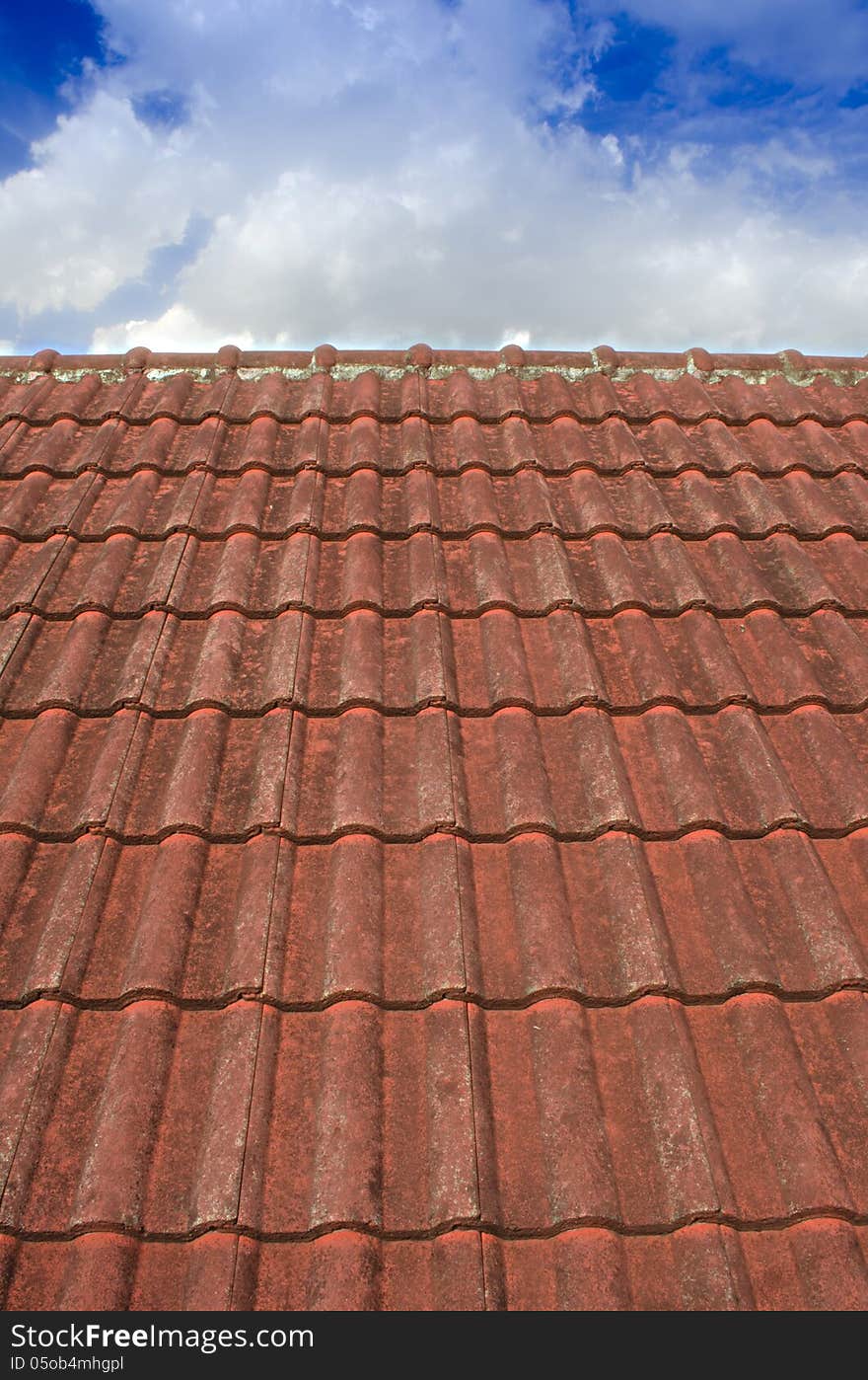 Tiled Roof with Fluffy Cloud Blue Sky