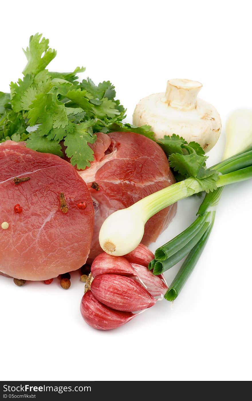 Perfect Boneless Raw Pork with Parsley, Spring Onion, Red Garlic, Edible Mushrooms and Spices isolated on white background