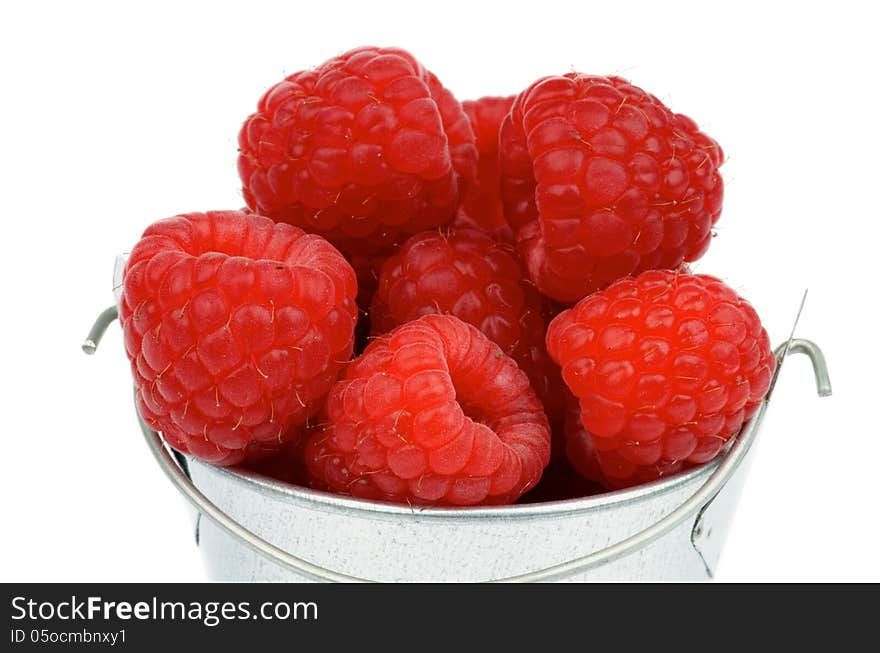 Perfect Ripe Raspberries in Cap of Tin Bucket isolated on white background. Perfect Ripe Raspberries in Cap of Tin Bucket isolated on white background