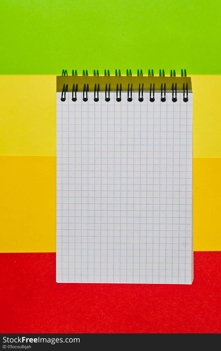 open note book with space for writing lies on a colorful background