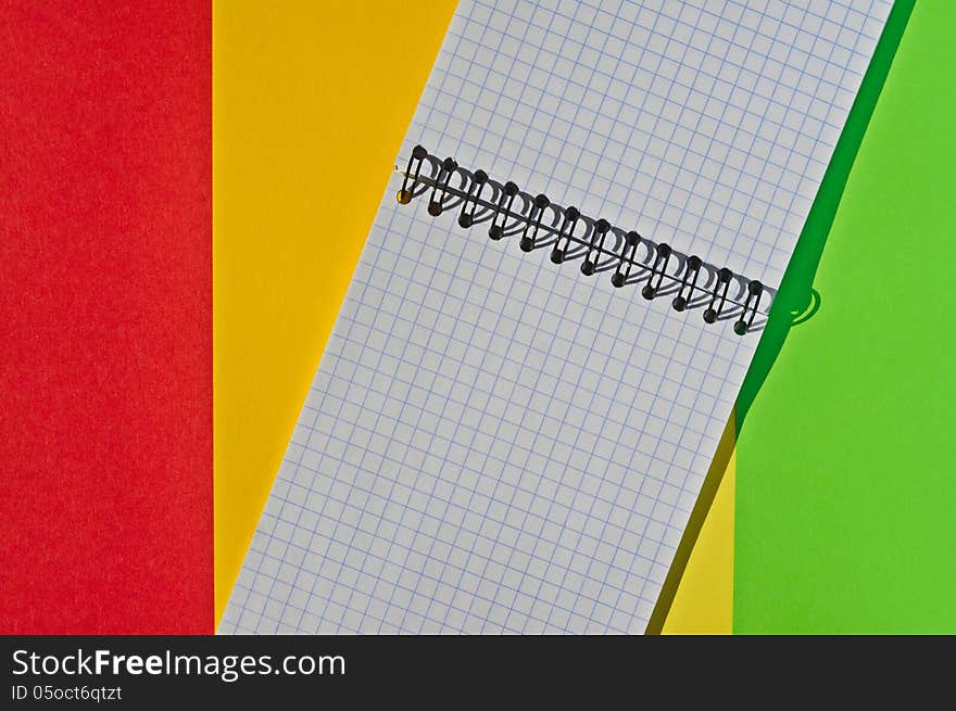 Open note book with space for writing lies on a colorful background