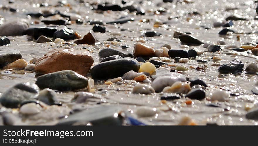 Close up of beach pebbles after rain