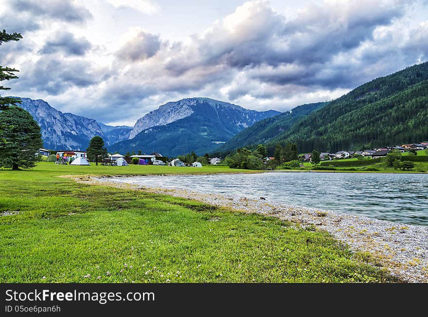 It is a lake near the mountains famous for camping. It is a lake near the mountains famous for camping.