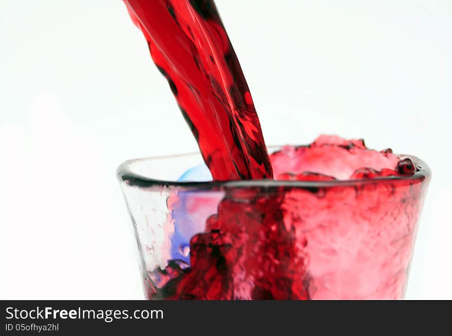 Pour red wine into glass. Pour red wine into glass