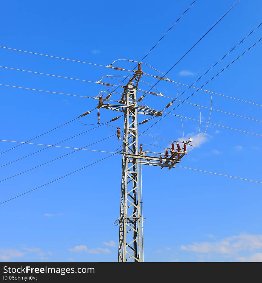 High voltage electricity pillars on the blue sky background