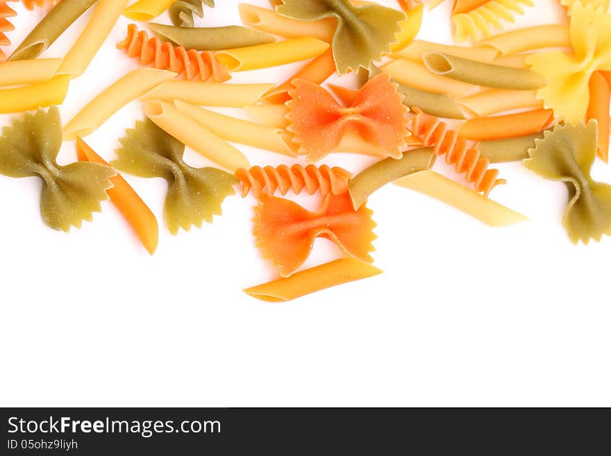 A different pasta in three colors close-up on the white background. A different pasta in three colors close-up on the white background.