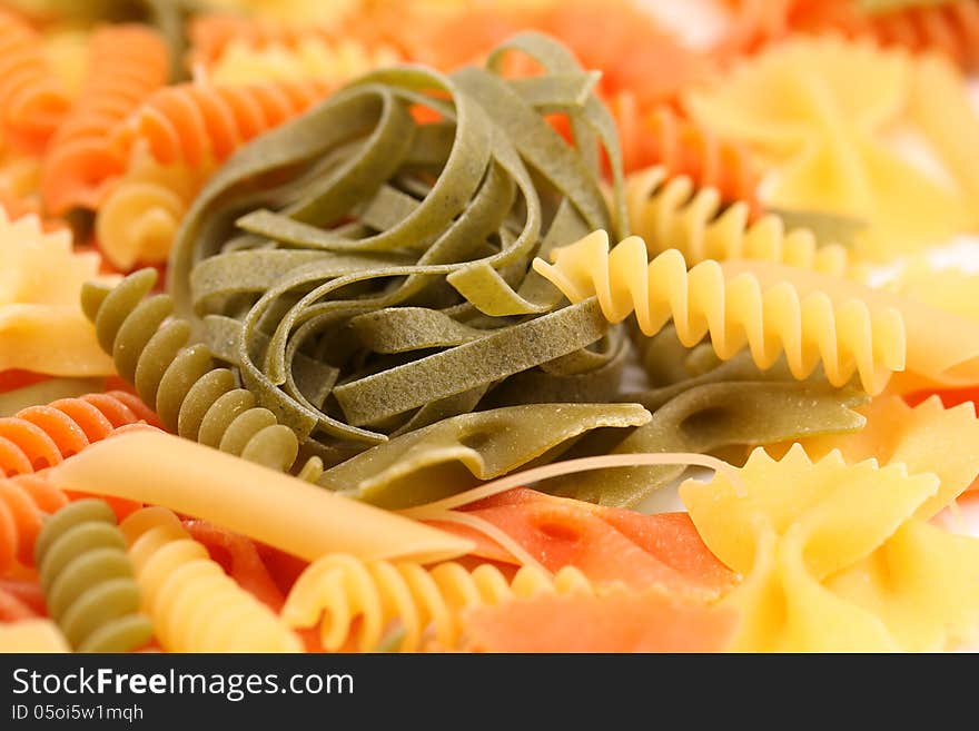 Different pasta in three colors. Close-up. Background.