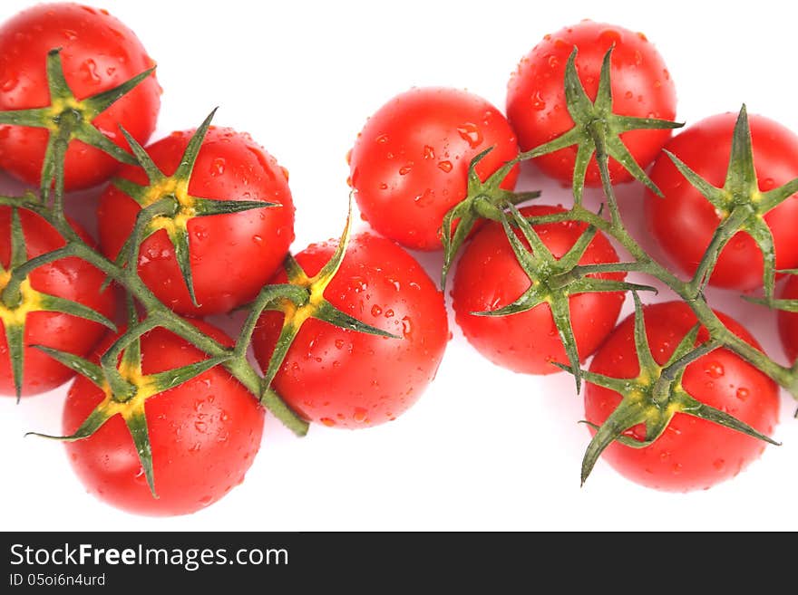 Two clusters of small red tomatoes