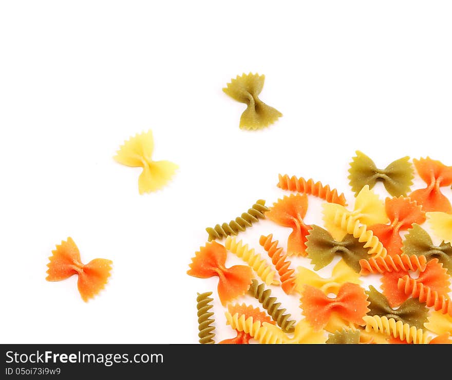 Different pasta in three colors. White background.