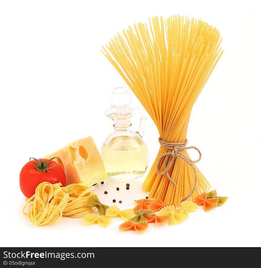 Different pasta, oil, tomato, cheese on a white background