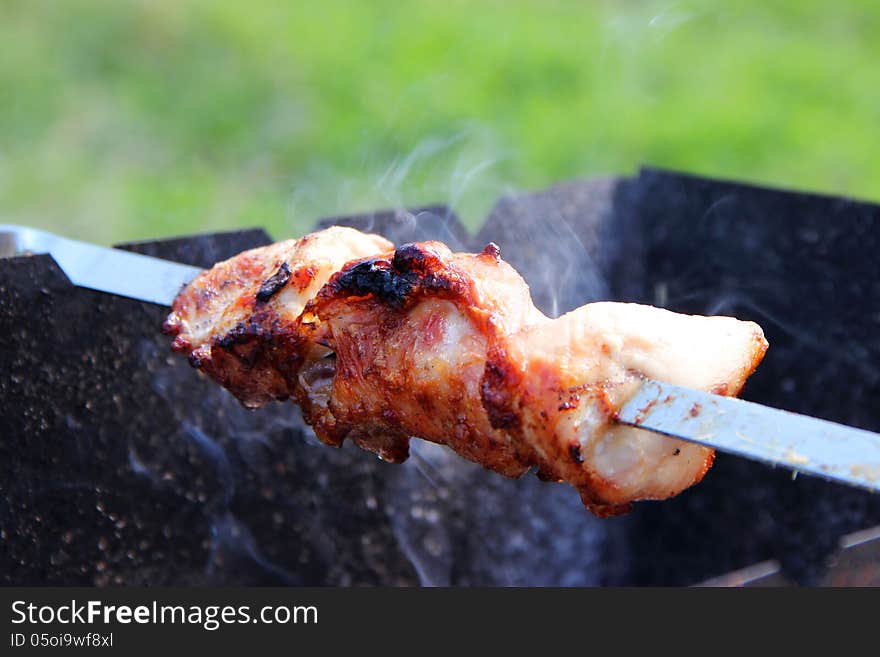 Barbecue grills over charcoal. bustier meat on a skewer. Barbecue grills over charcoal. bustier meat on a skewer